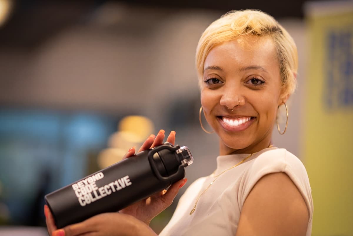 Community member with Beyond Code Collective water bottle