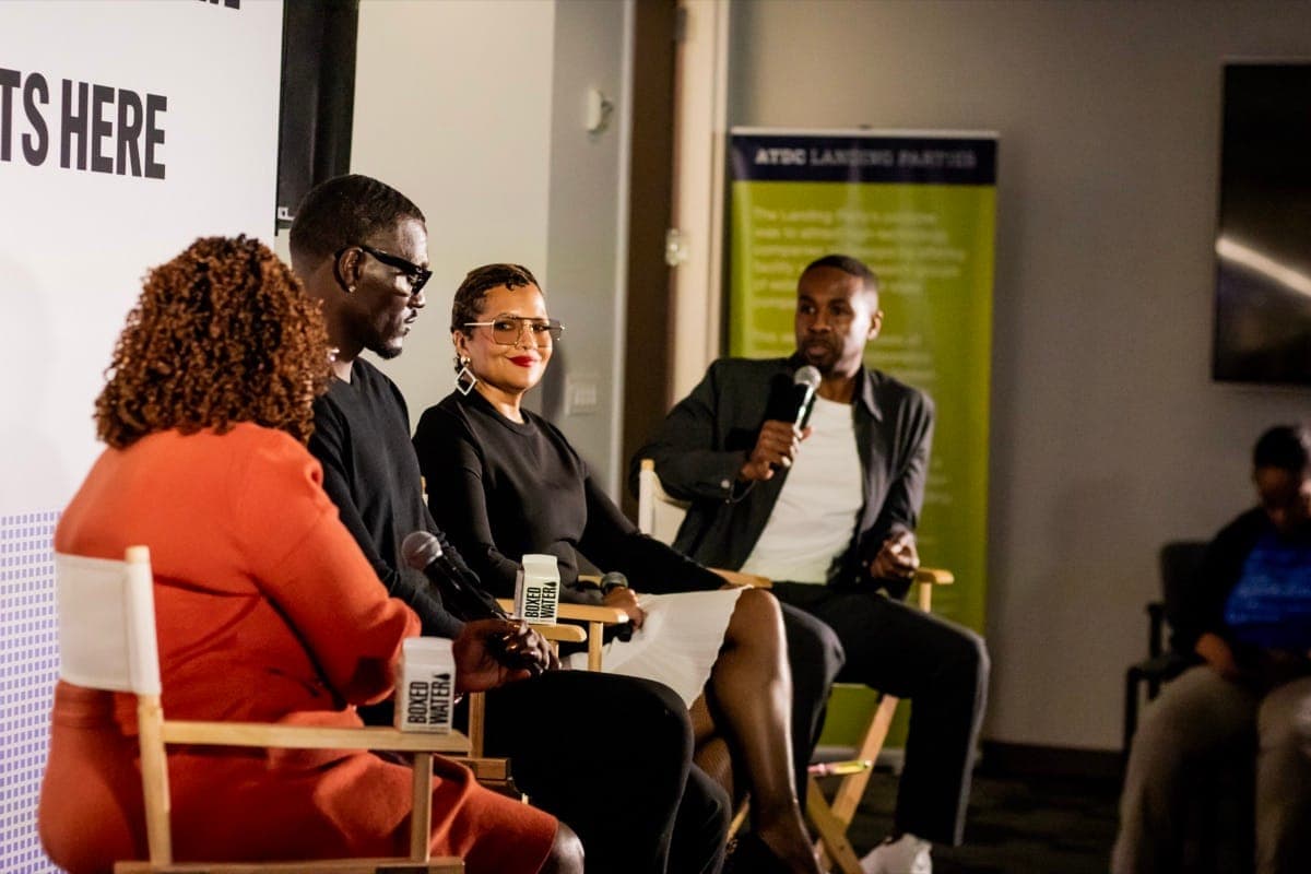 Panelists in conversation on stage at The Forge